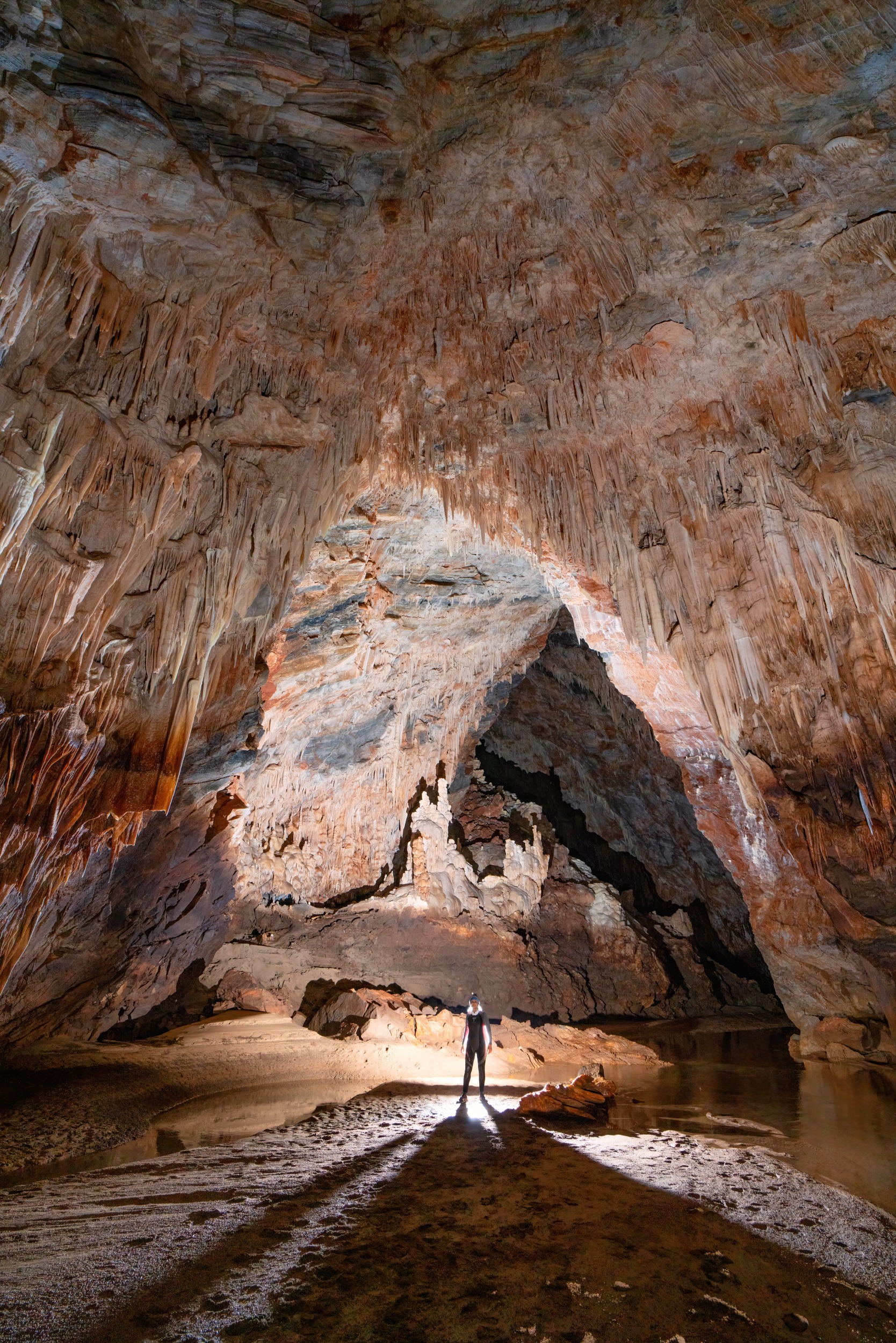 Large passage with an underground river inside Aggitis River Cave
